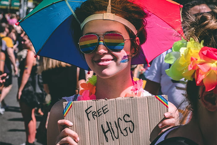 Person showing sign that says Free Hugs